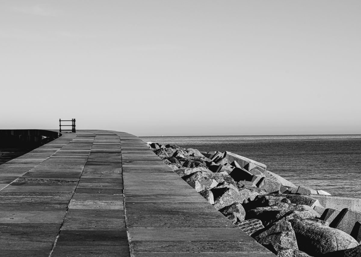 A seafront promenade walkway running out toward Galway Bay