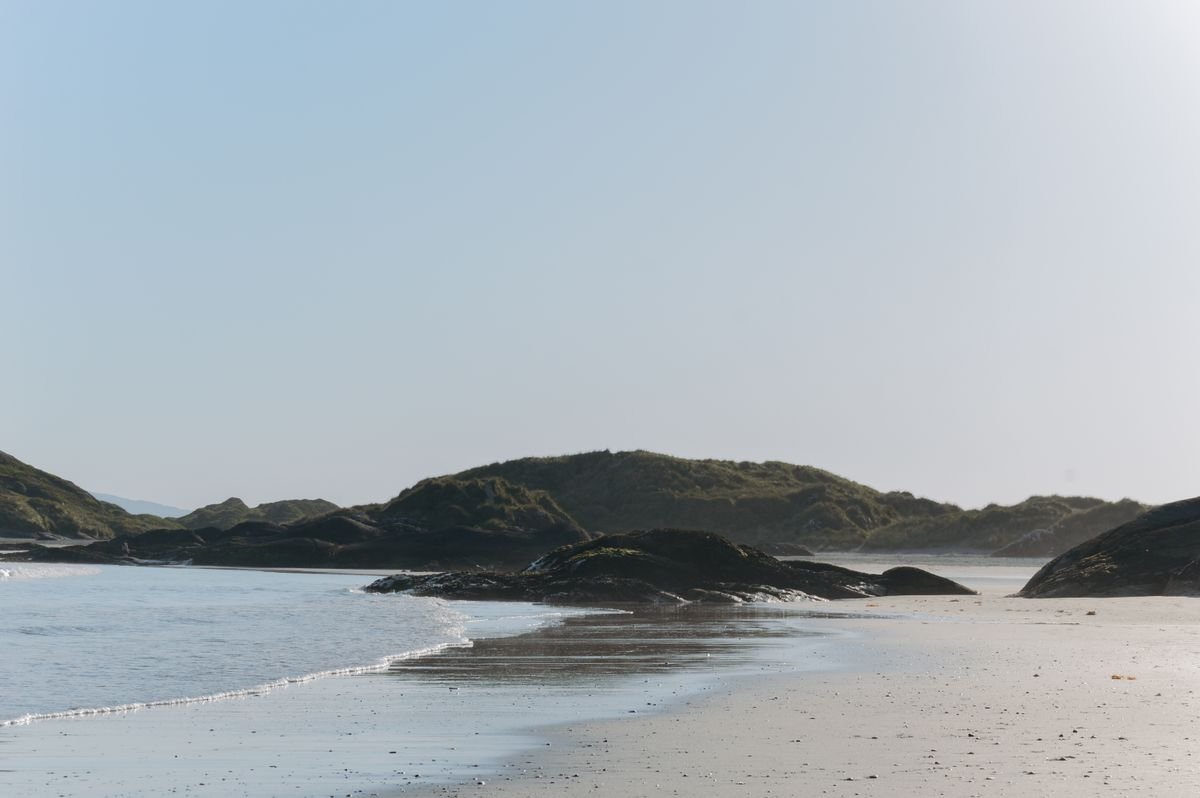 Sunny dune-backed sandy beach on a bright day in Ireland