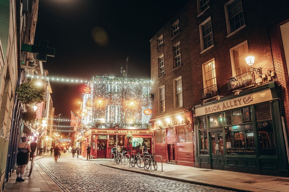 Cobbled Dublin street lit up at night near Temple Bar