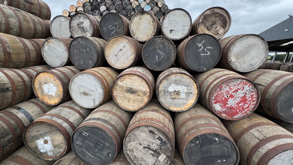 Stacked oak whiskey aging barrels