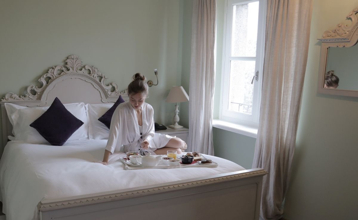 Bright bed and breakfast room with a breakfast tray on the bed