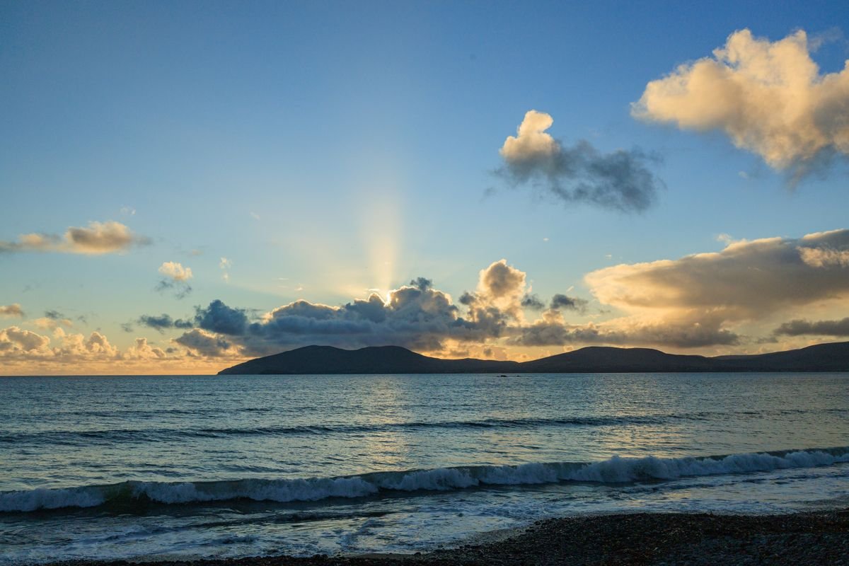 Sunset over the Atlantic with mountains and waves on the west coast of Ireland