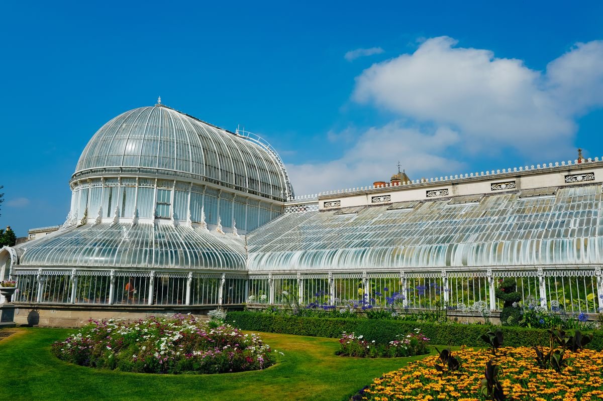 The Victorian Palm House glasshouse and flower beds at Belfast Botanic Gardens