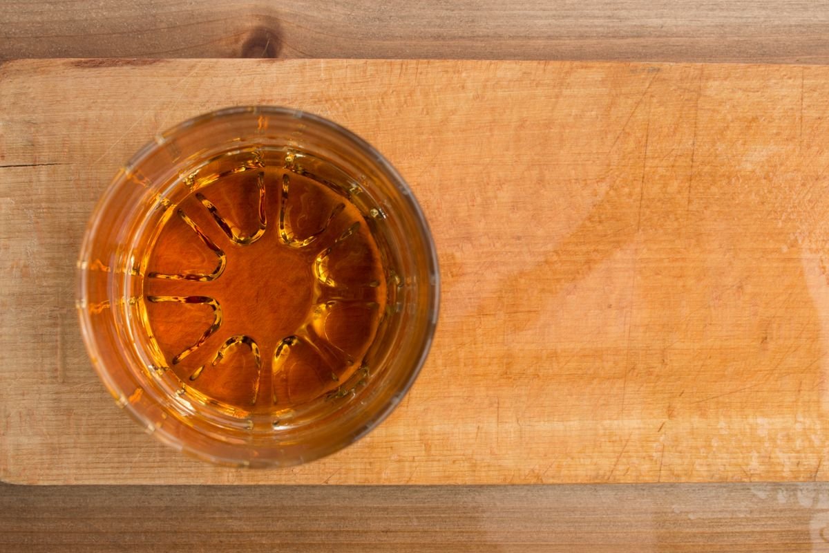 A glass of Irish whiskey viewed from above on a wooden board