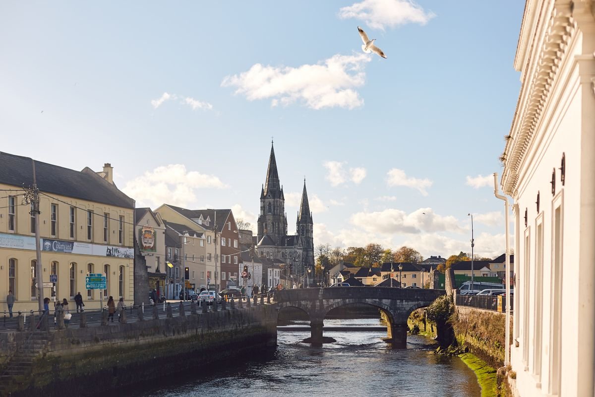 River Lee flowing through Cork city with St Fin Barre's Cathedral spires in the distance