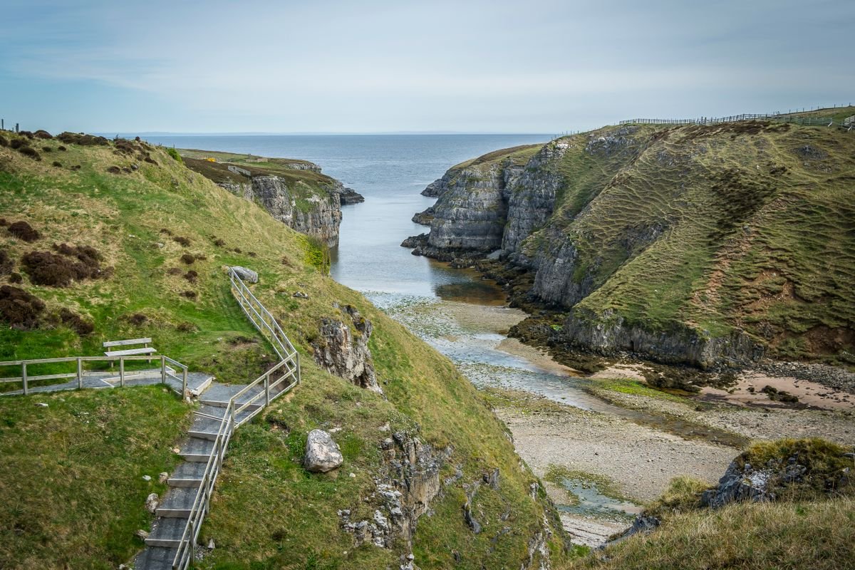 Steep steps descending a cliff to a cove on the Antrim coast