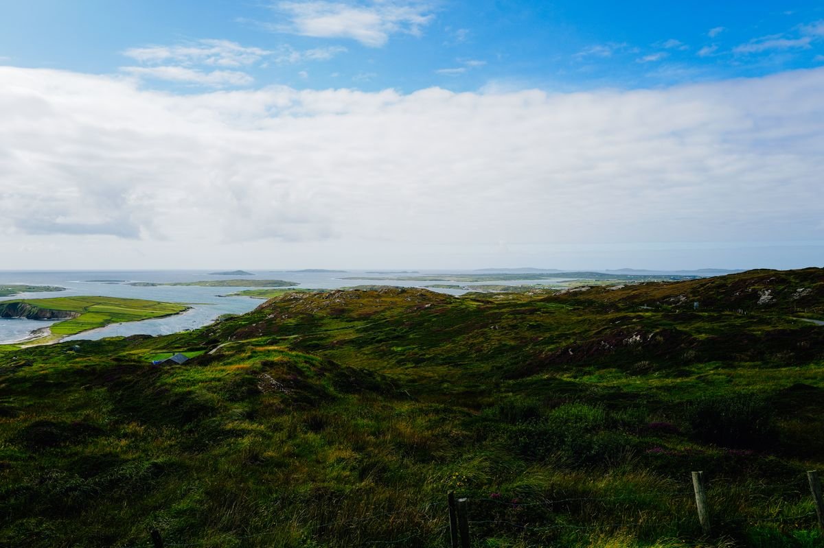 Green Connemara coast under blue sky on the west coast of Ireland