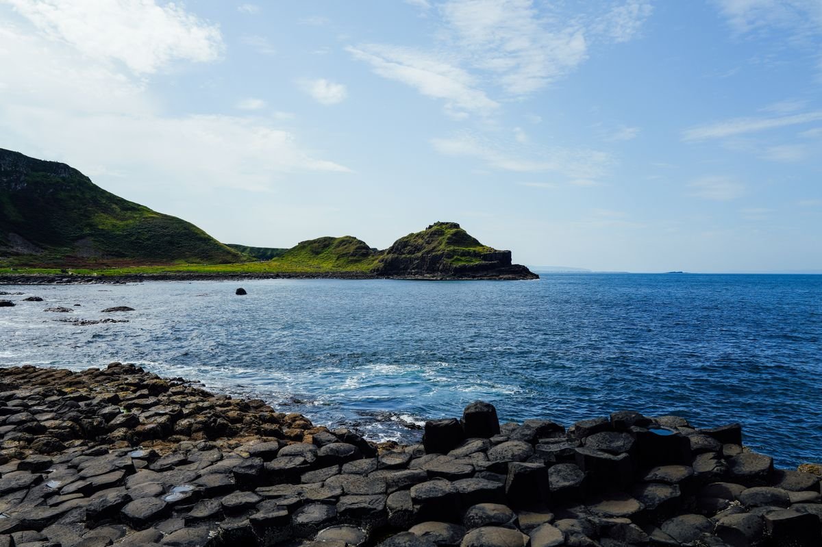 The green headland and blue sea coastline around Carrick-a-Rede