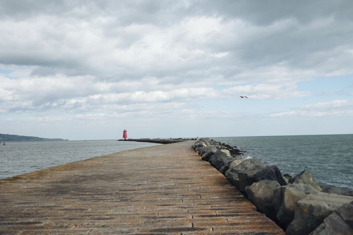 The Great South Wall stretching into Dublin Bay toward the red Poolbeg lighthouse