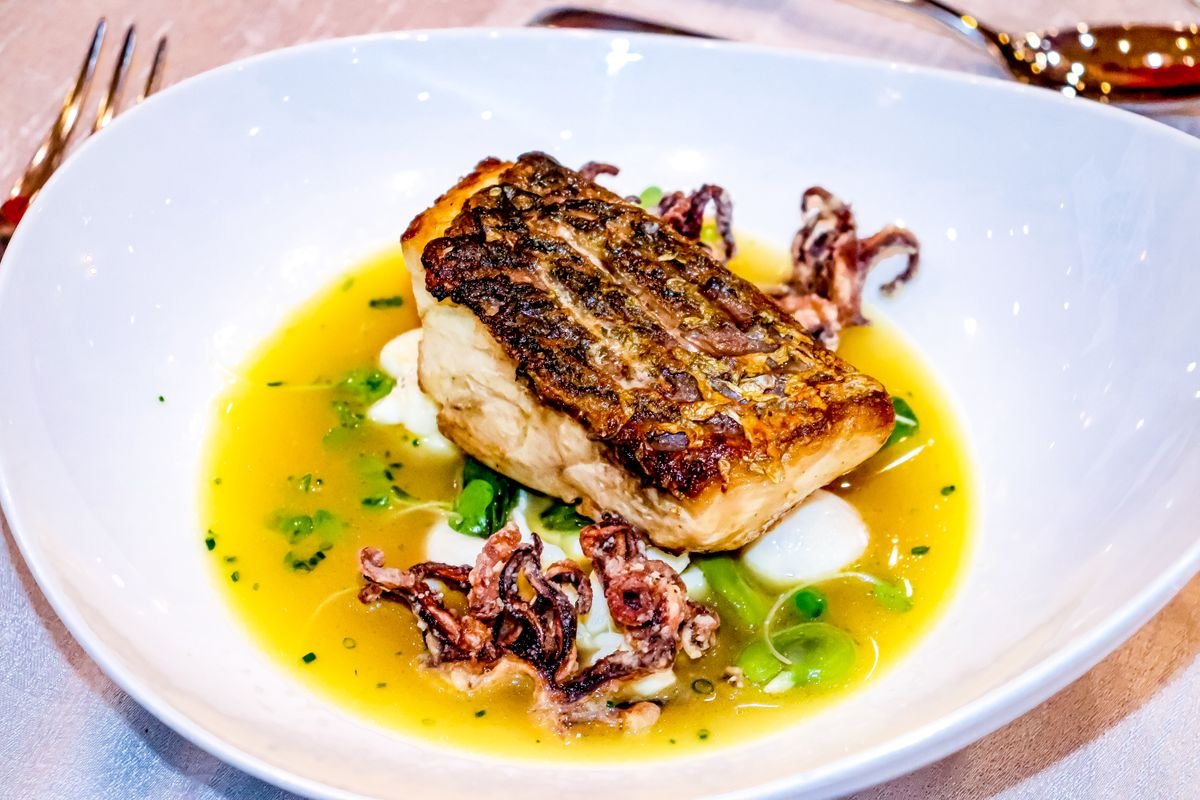 Pan-seared fish fillet plated at a restaurant