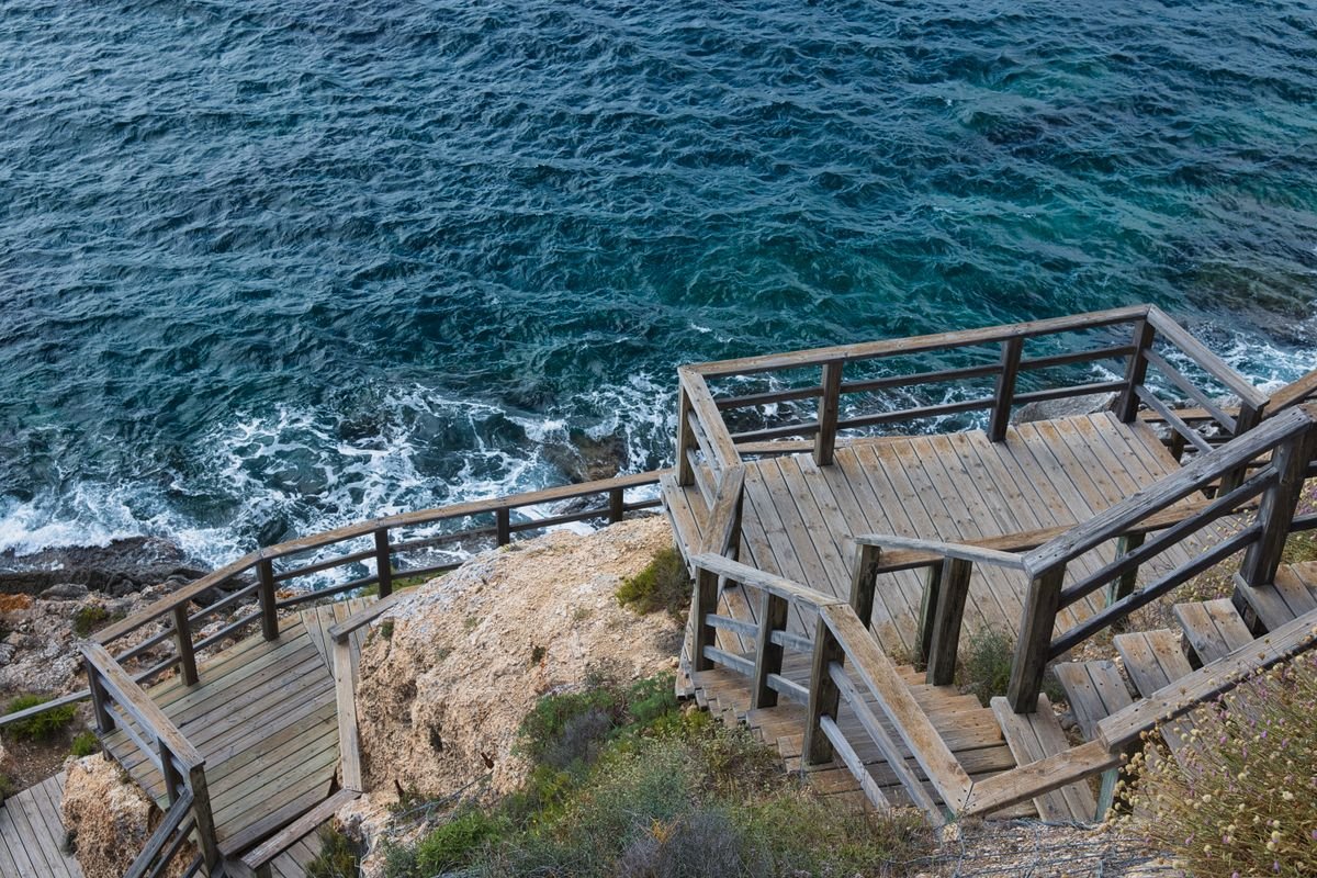 Wooden steps descending a cliff to the sea