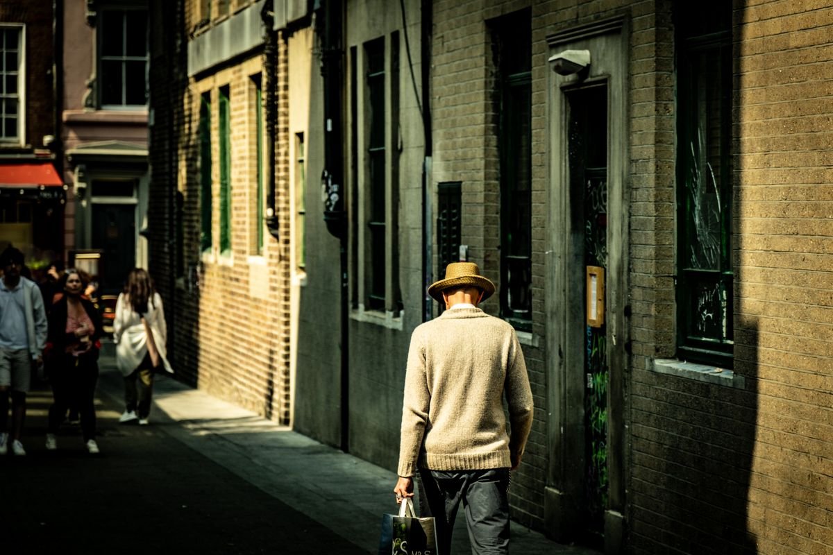 Person walking a narrow city center lane in Cork