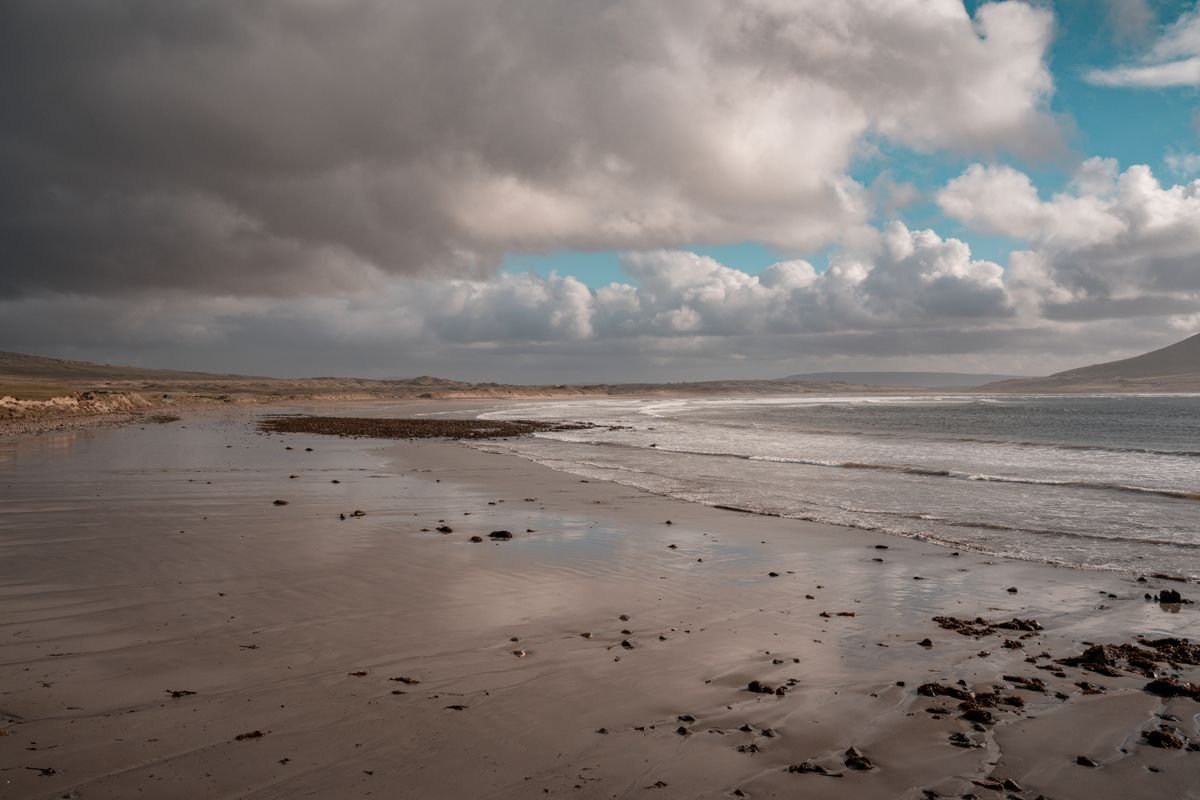 Keel Beach on Achill Island, a long flat strand backed by dunes and hills