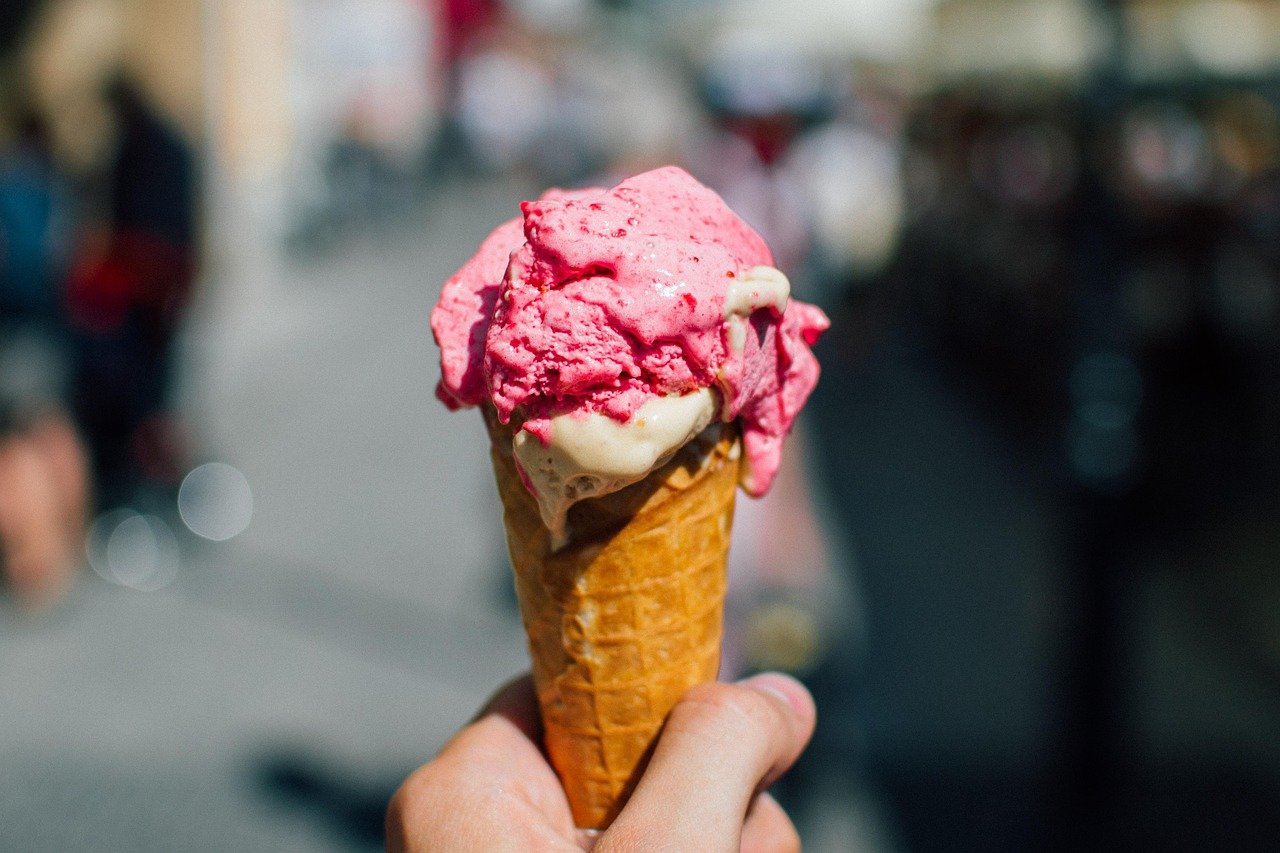 A hand holding an ice cream cone on a Dingle street, home of Murphys ice cream