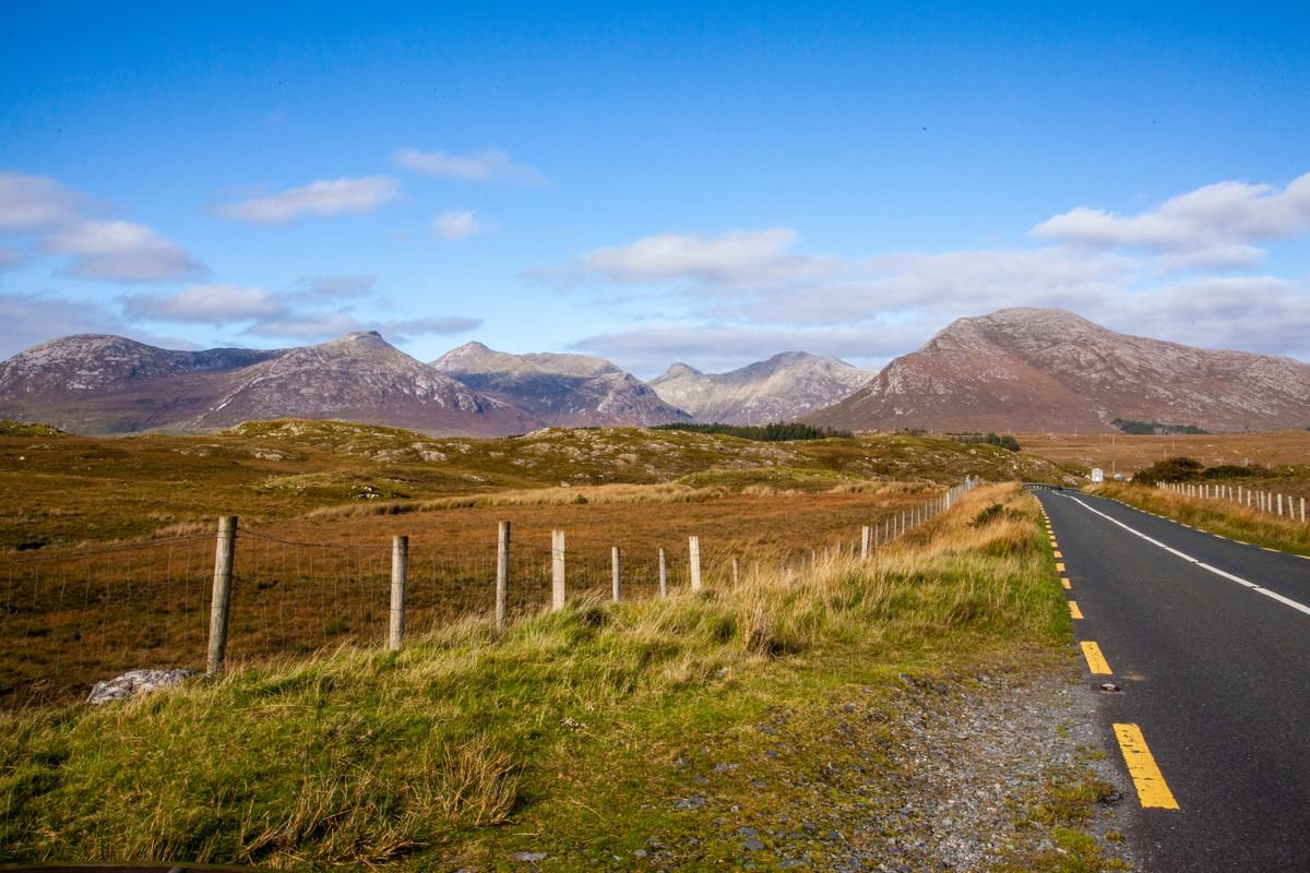 The Connemara mountains rising behind an open road near Galway