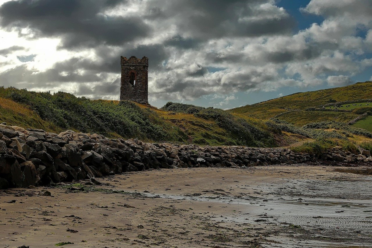 Ruined Minard Castle standing above a boulder beach on the Dingle Peninsula