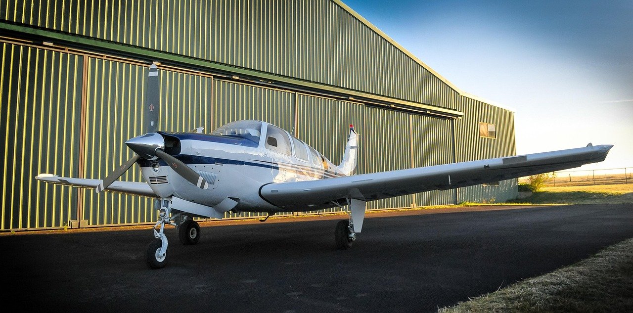 Small propeller plane parked by a hangar at a regional airport near Dingle