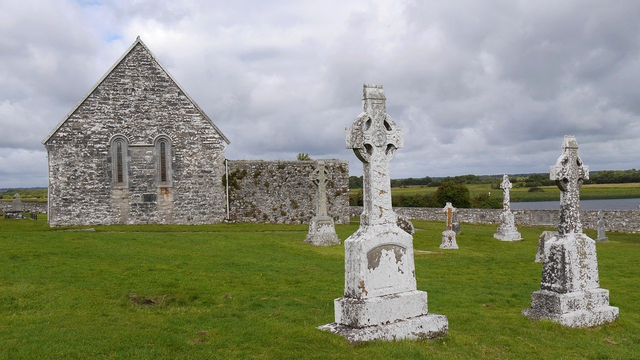 Stone church ruin and carved Celtic crosses at the Glendalough monastic site