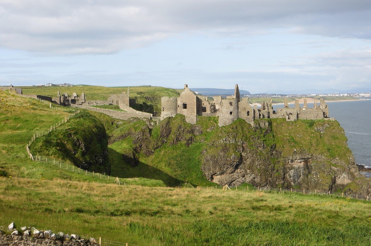 Ruins of Dunluce Castle perched on a cliff edge above the sea