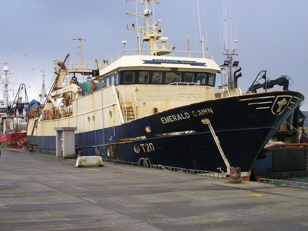 A fishing trawler tied up at the working pier in Dingle harbour