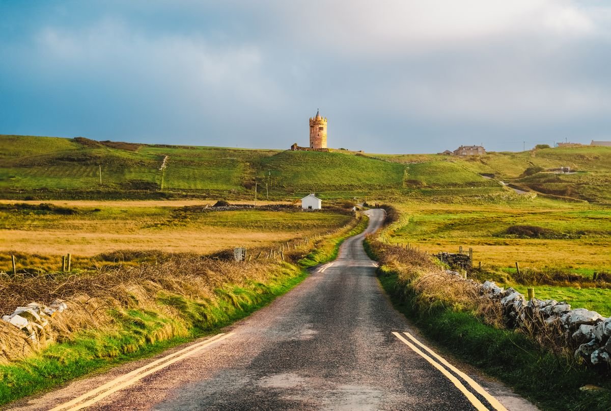 Doonagore Castle above a winding road near Doolin in County Clare