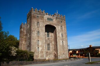 Bunratty Castle tower house against a blue sky in County Clare