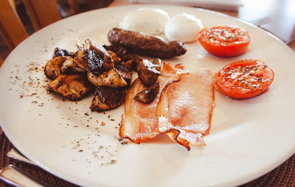 Cooked breakfast with bacon sausage and eggs