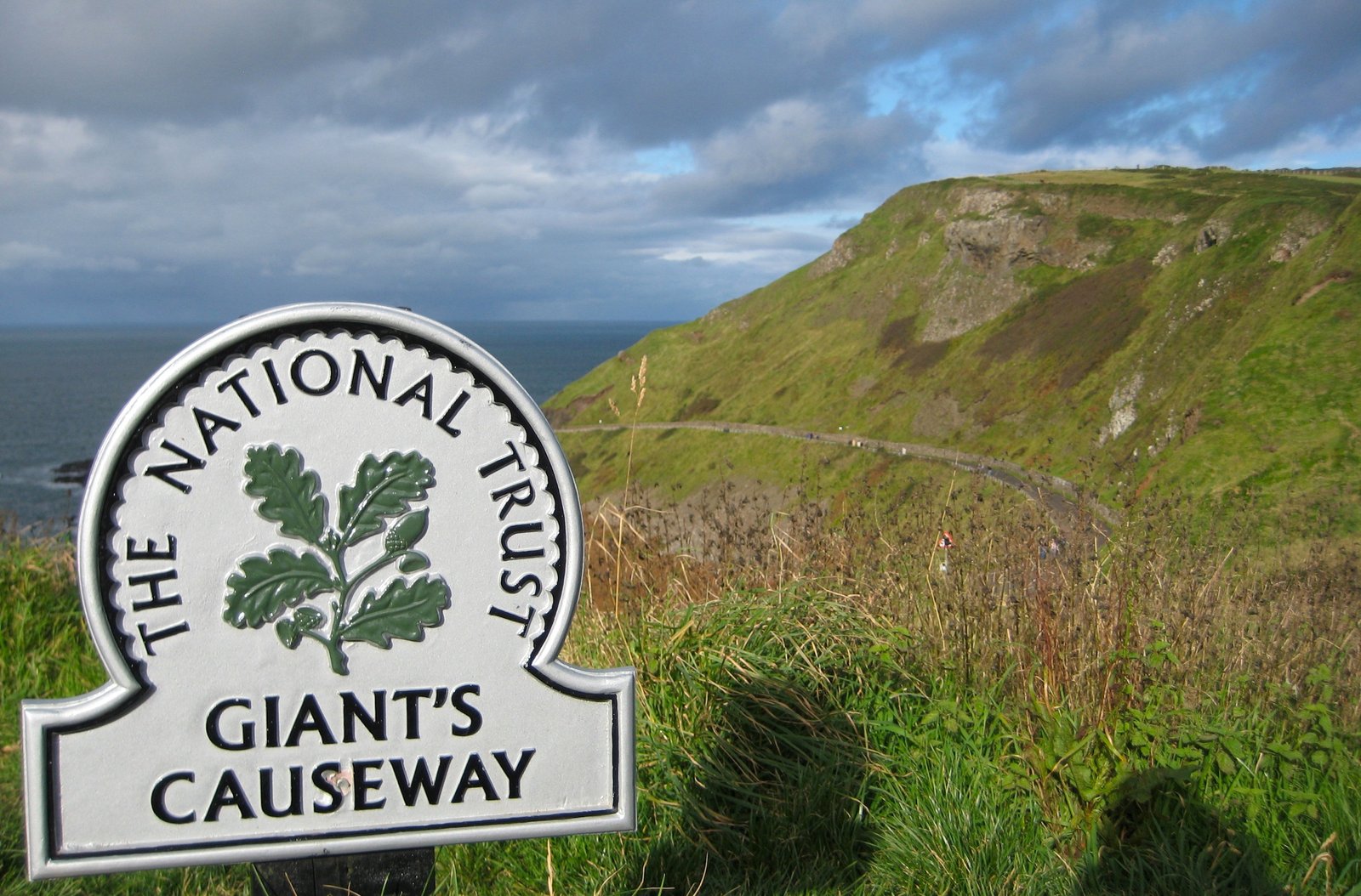 The National Trust sign for the Giant's Causeway beside the coastal road