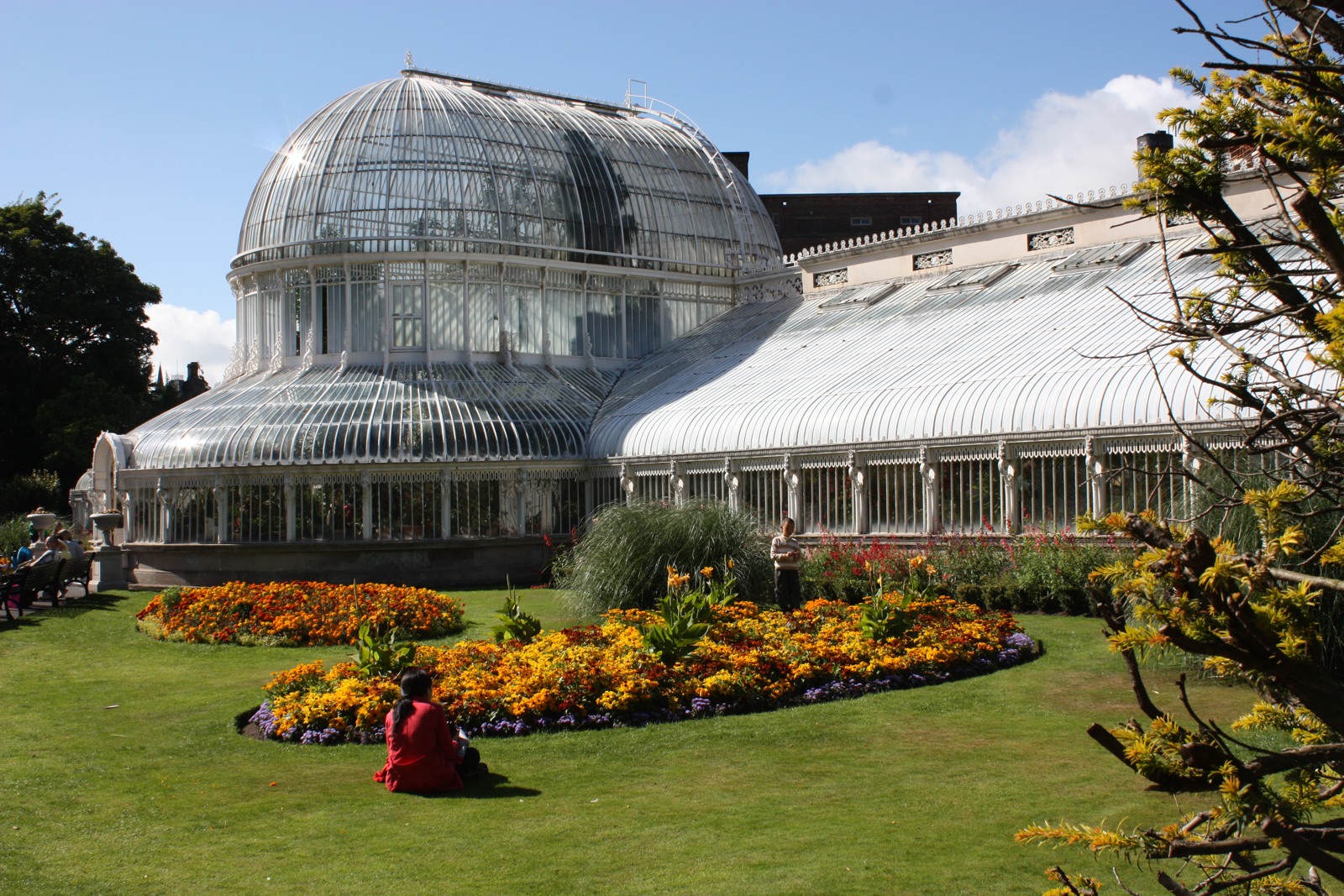 The glass Palm House and flower beds in Belfast Botanic Gardens
