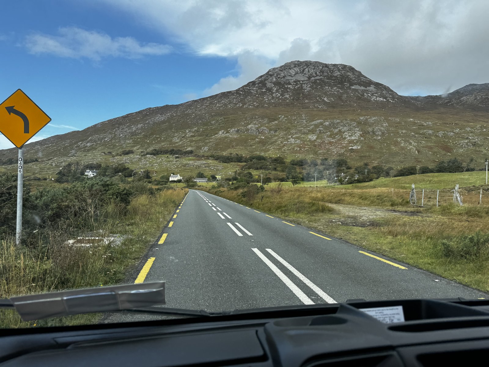 Driving through Connemara with a dramatic rocky mountain peak visible ahead through the campervan windscreen