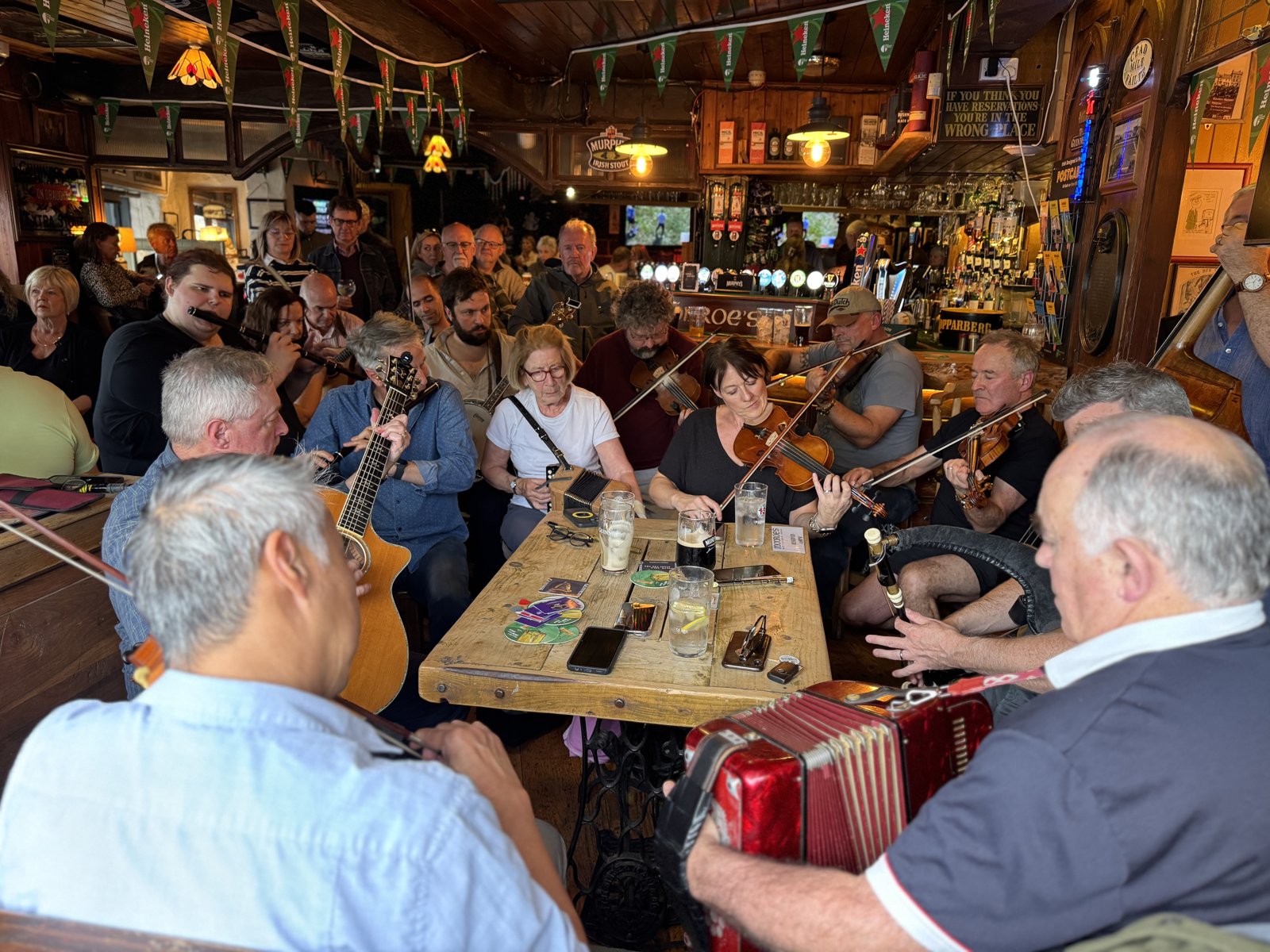 Musicians playing fiddles and accordion in a Galway pub