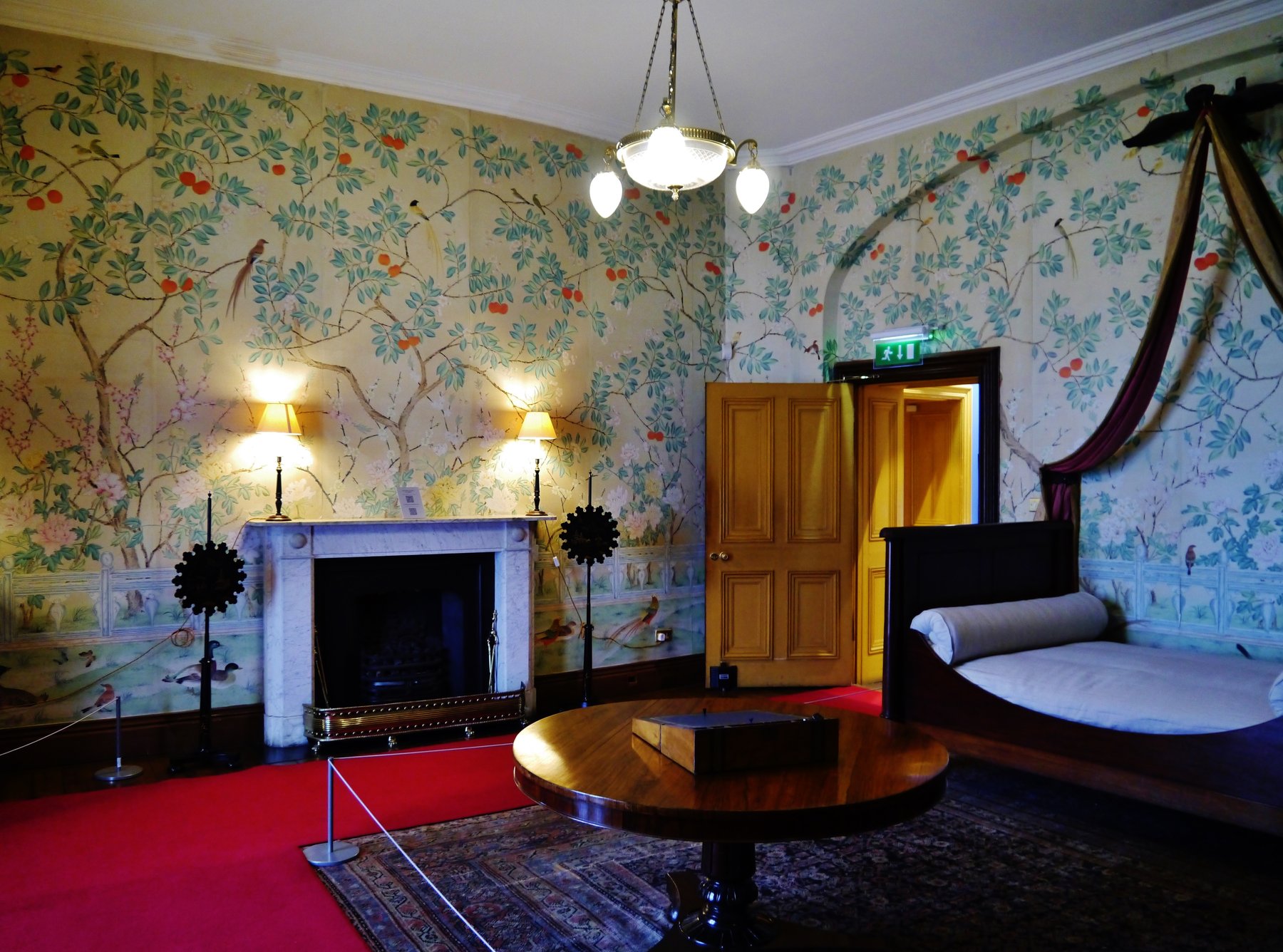 A furnished room with floral wallpaper inside Kilkenny Castle