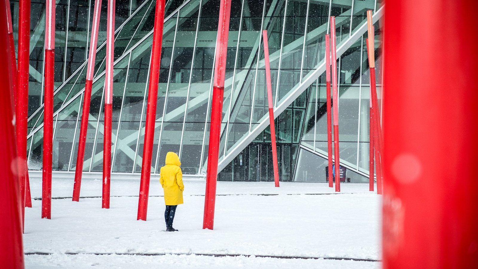 Person wearing a yellow hooded coat in snowy Dublin