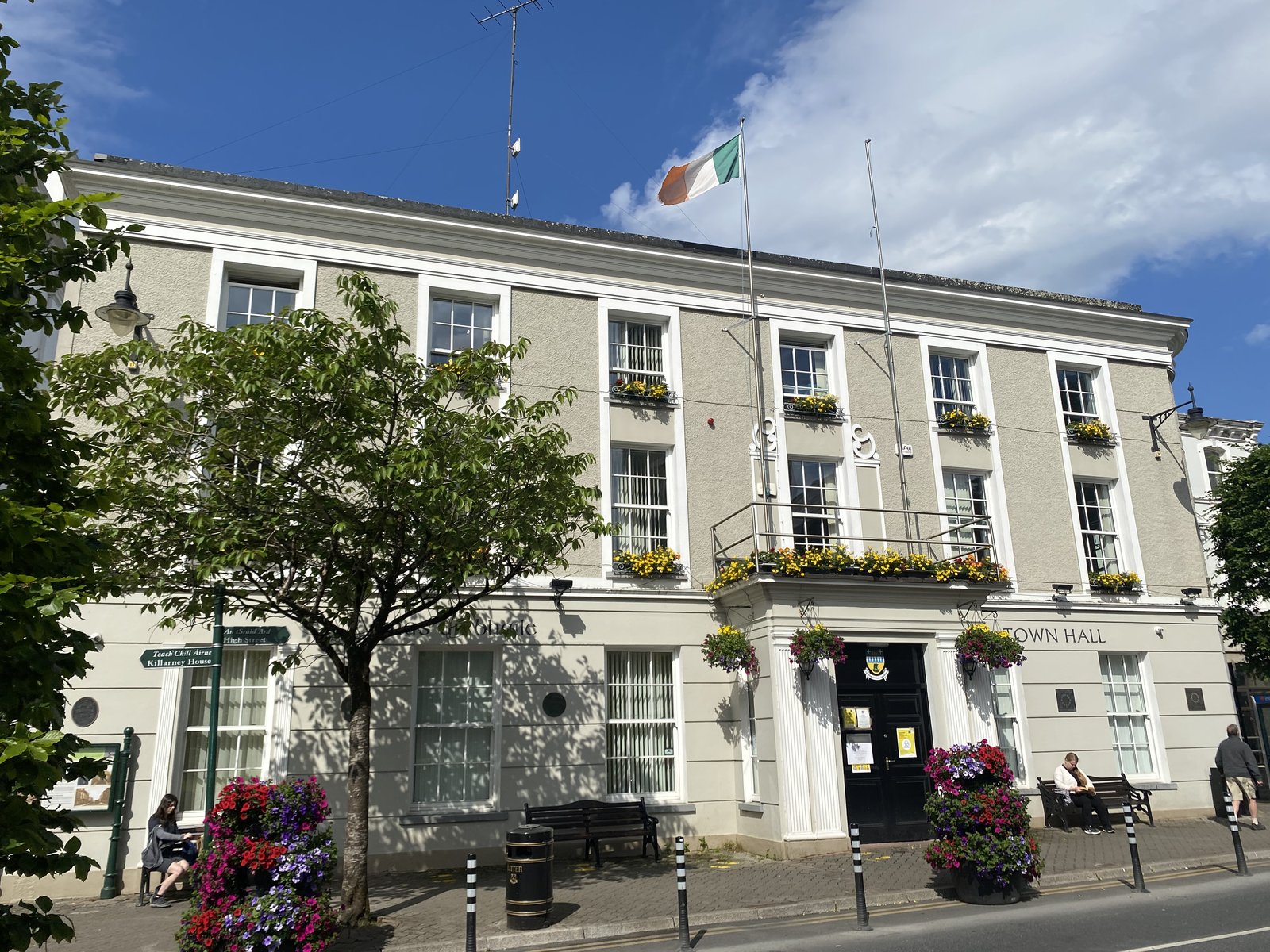 Killarney Town Hall with flowers outside in June