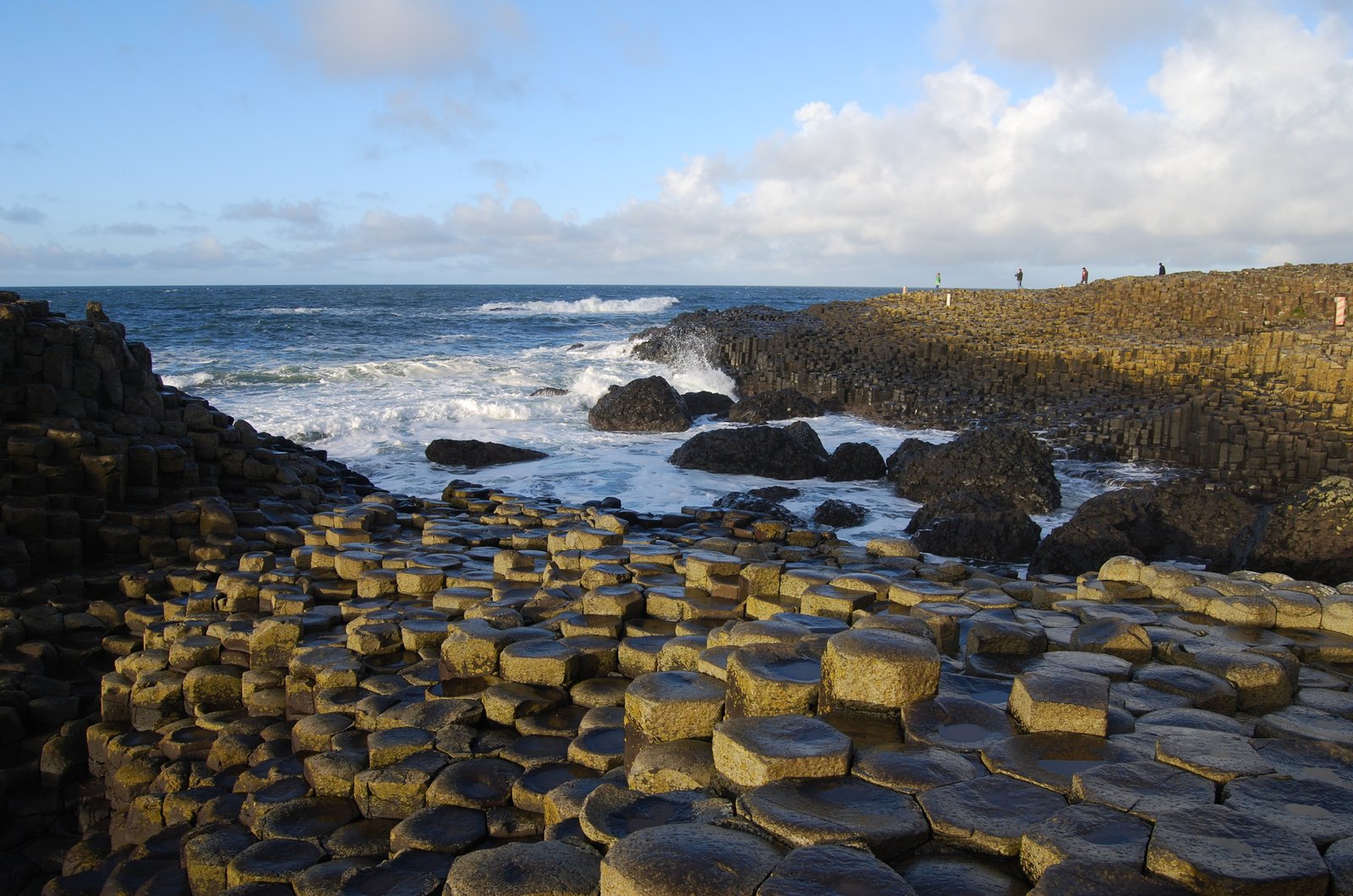 Late light on the basalt columns of the Giant's Causeway with waves breaking behind