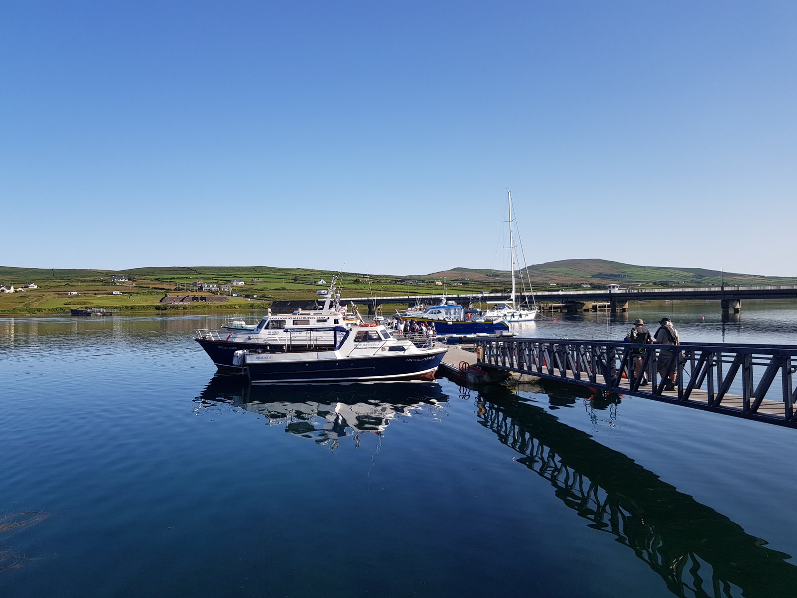 Tour boats moored beside the pier at Portmagee