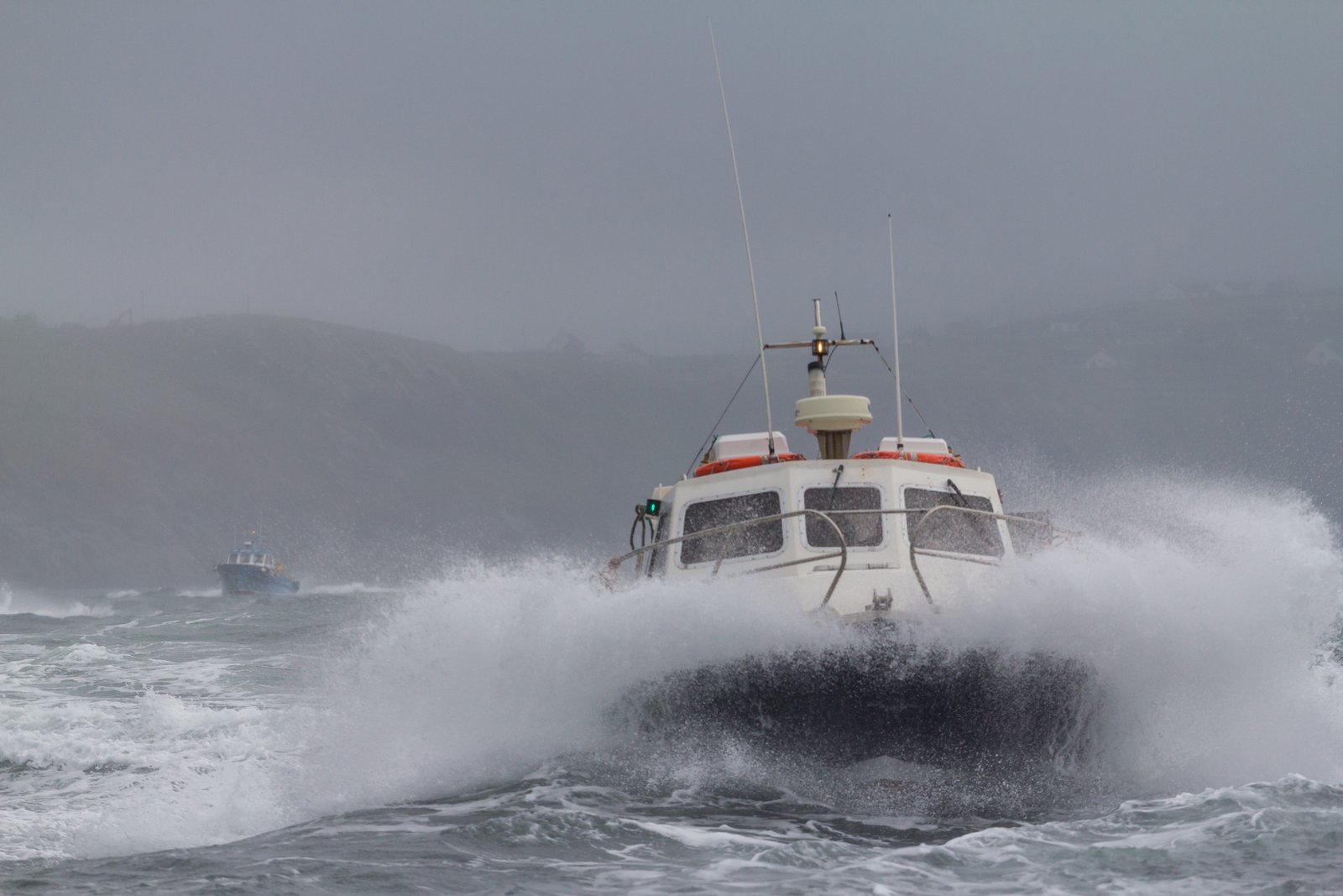 A Skellig Michael tour boat crashing through rough Atlantic swell near Portmagee