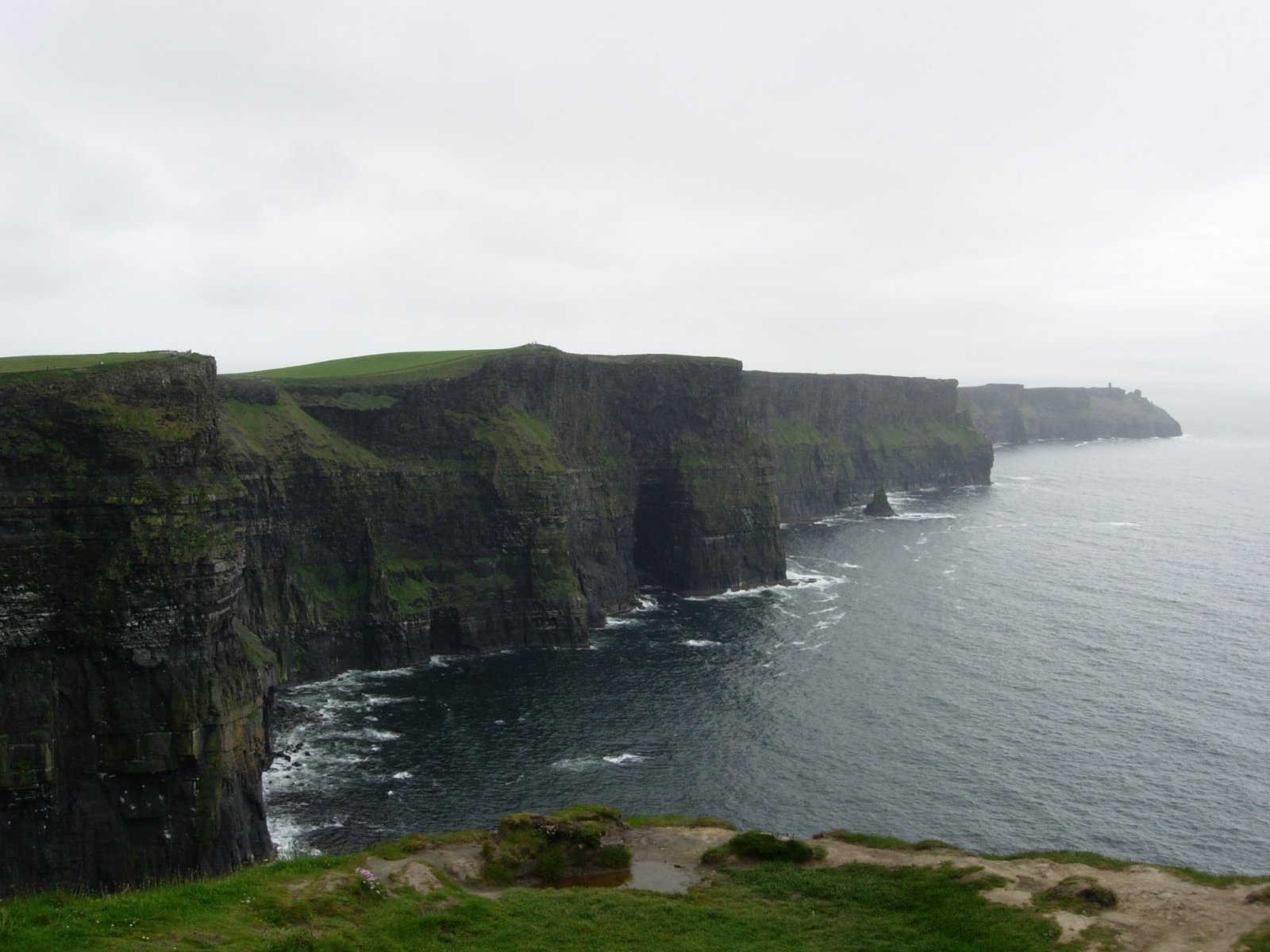 The Cliffs of Moher under flat grey overcast, the conditions that dull the view without hiding it