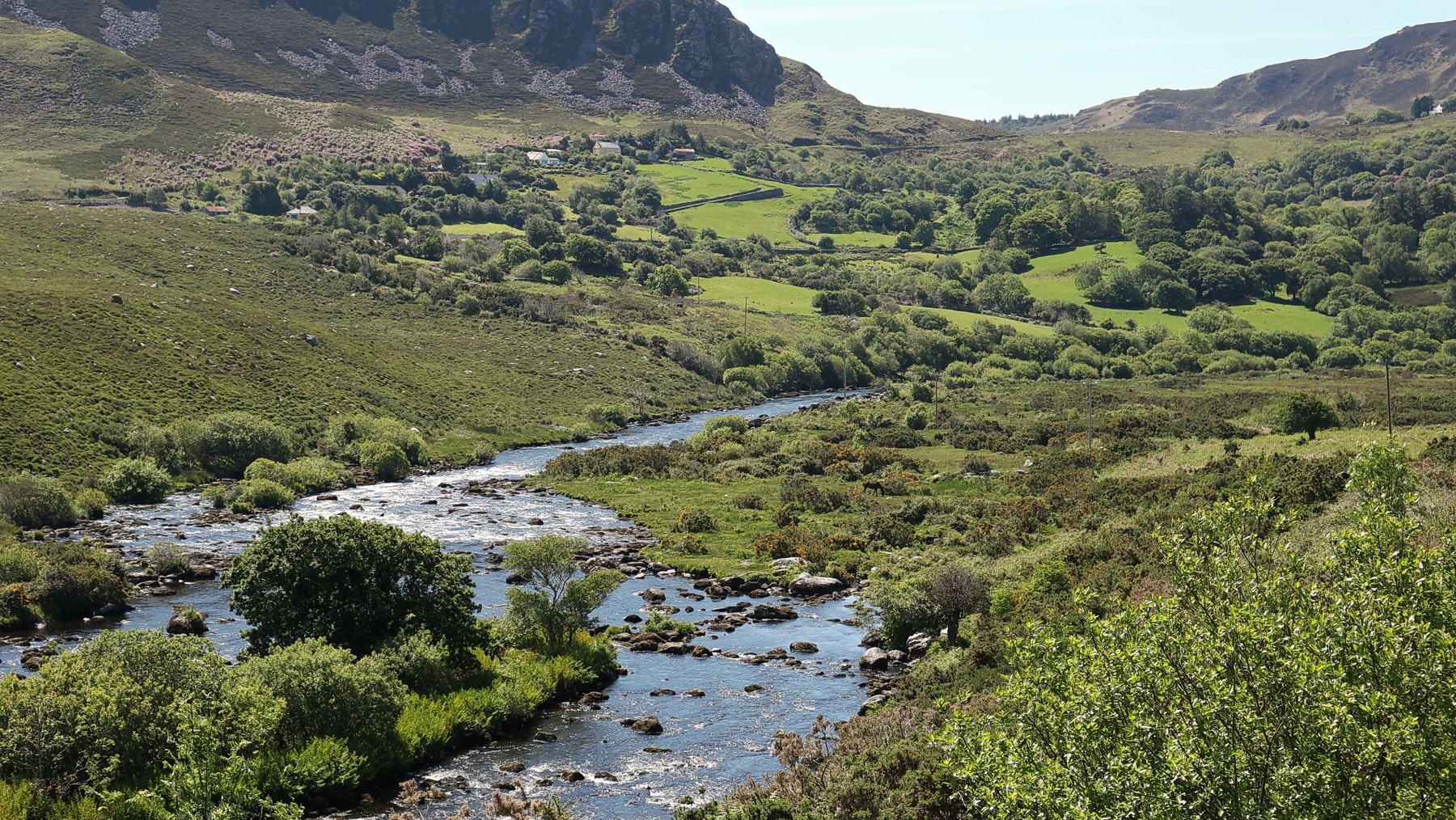 The Caragh River winding through a green mountain valley in Kerry