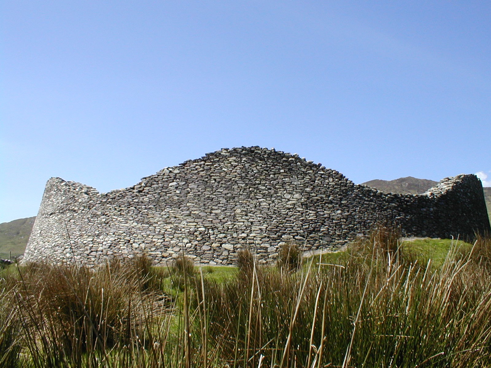 Dry-stone outer wall of Staigue Fort beneath a blue sky