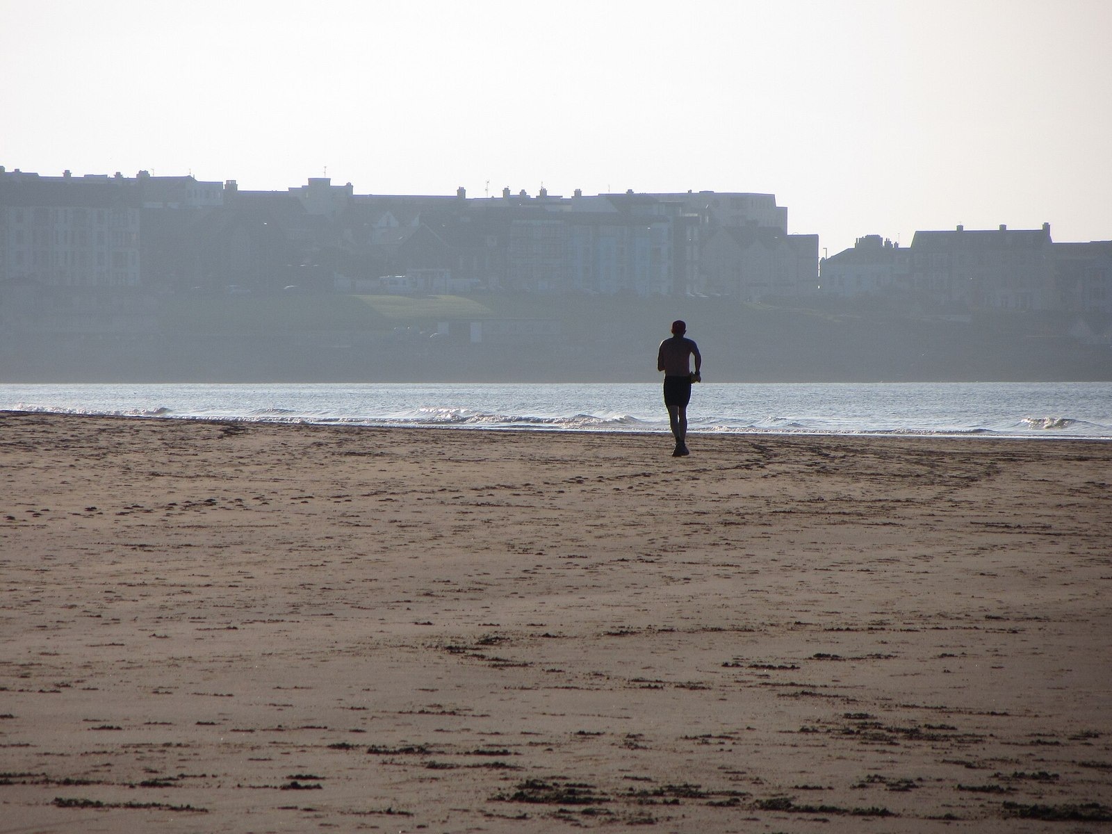 A runner on the broad beach at Portrush