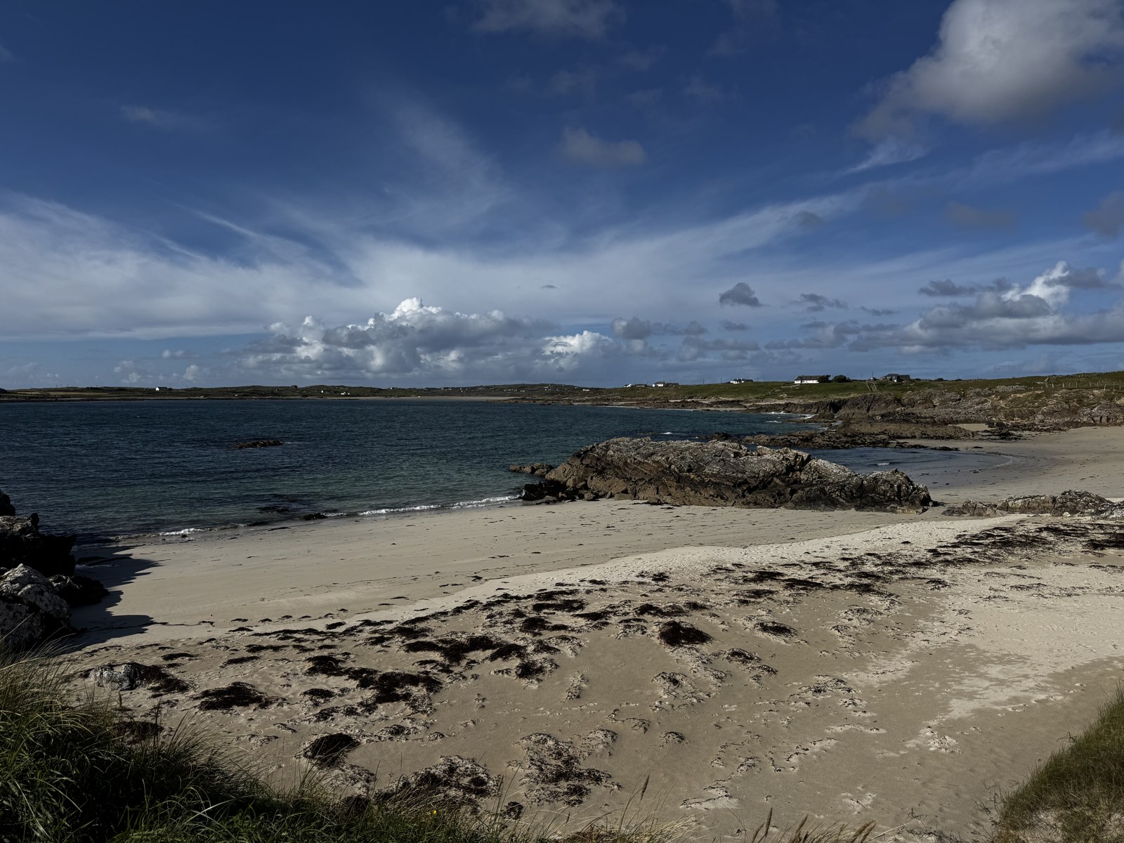 Sandy shoreline and rocks on the coast near Clifden