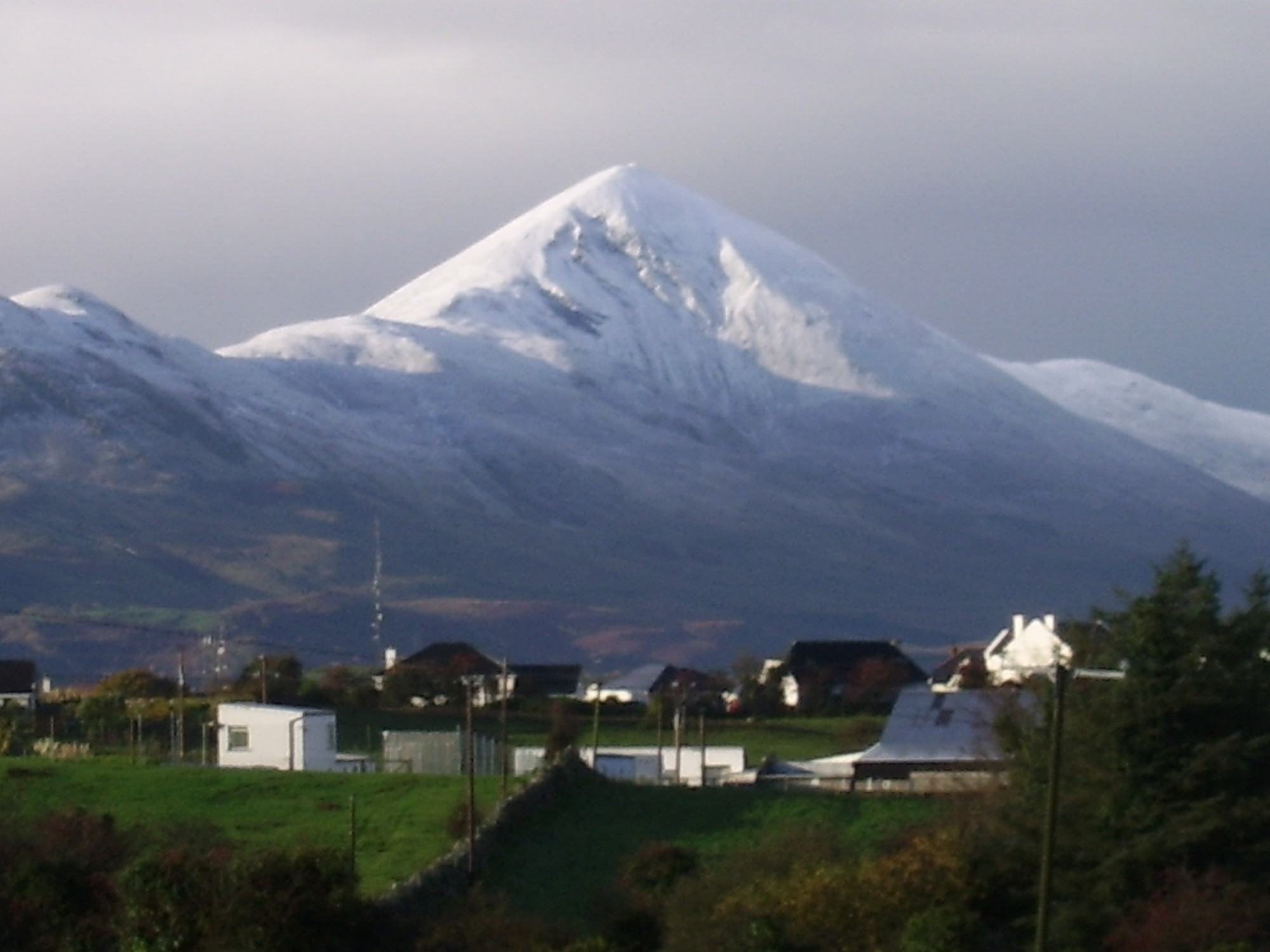 Snow covering Croagh Patrick above buildings at its foot