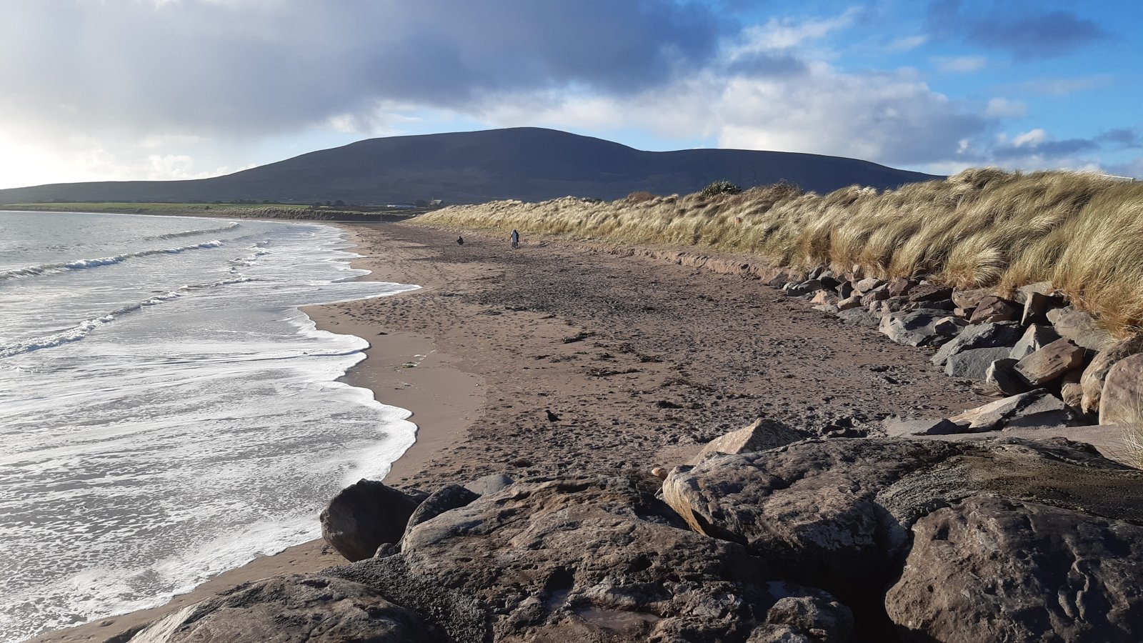 Ventry beach and dunes beneath mixed clouds