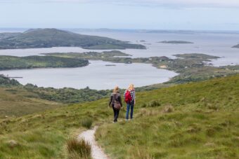 Hikers on Diamond Hill looking toward the Connemara coast