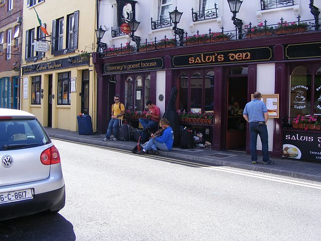 Archive photograph of musicians outside a pub on Main Street in Kinsale