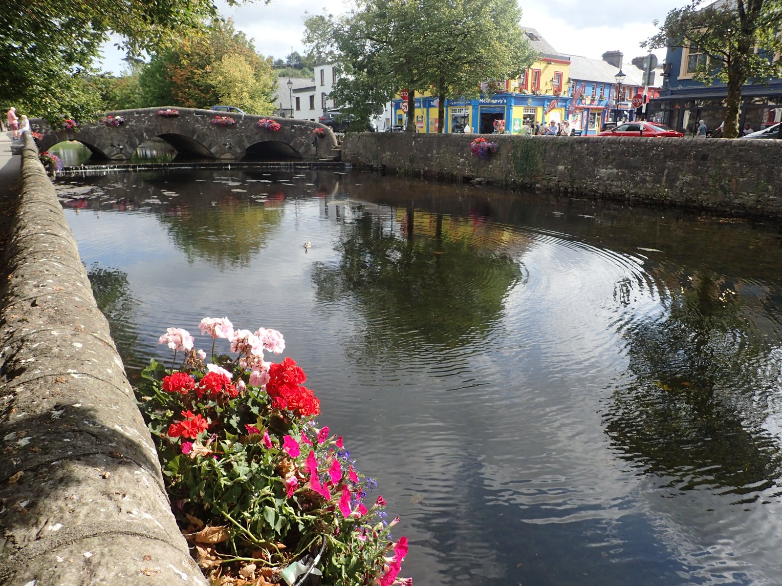 Stone bridge and colorful buildings beside the Carrowbeg River in Westport