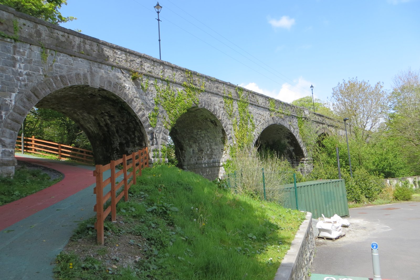 Path passing beneath a stone bridge in Westport